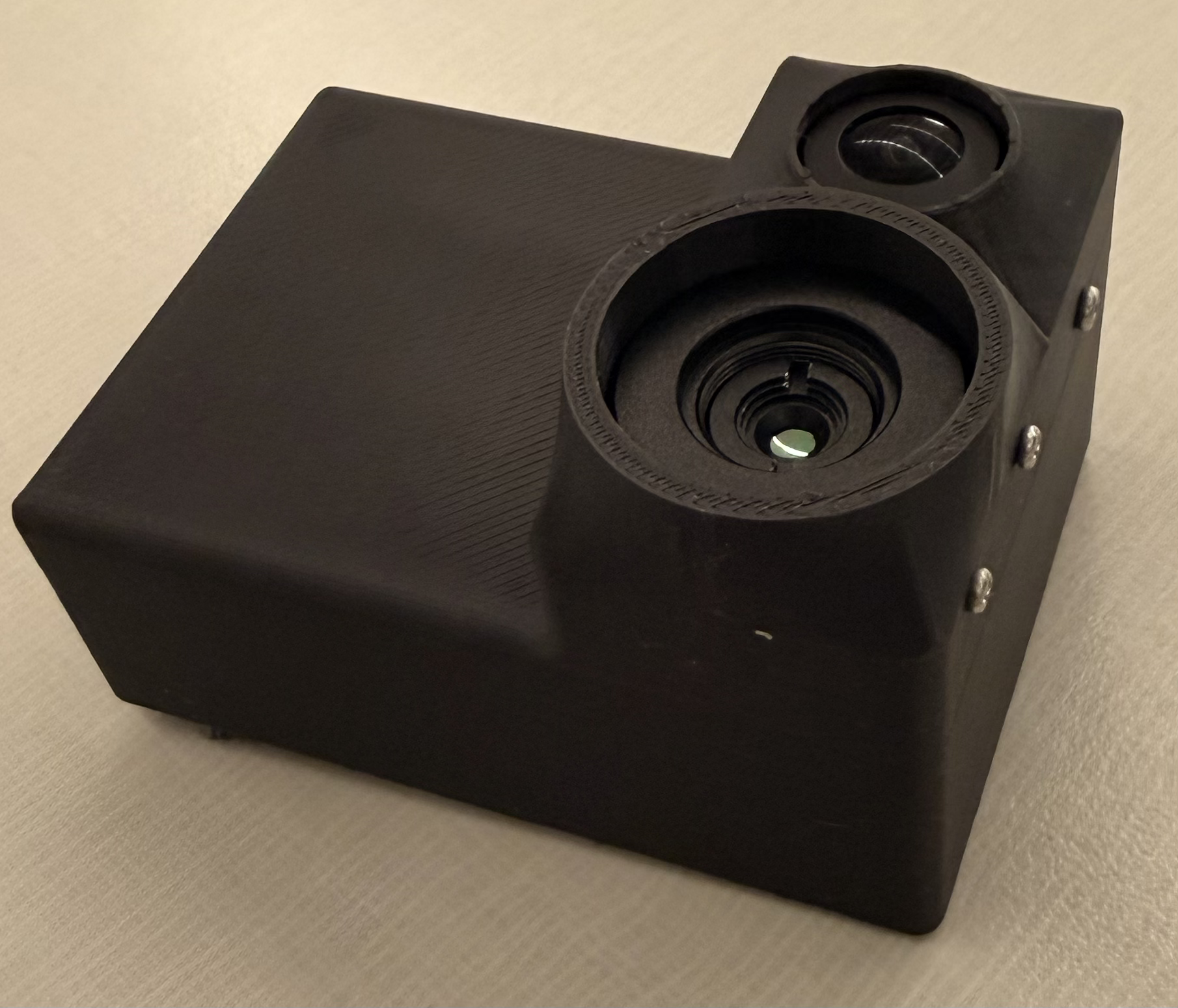 V2 shell front view showing fisheye and thermal lens apertures